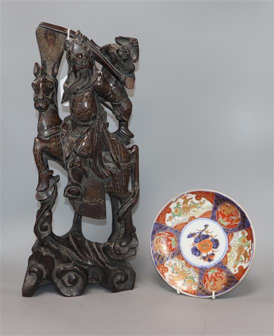 A Chinese carved hardwood figure of a warrior and an Imari plate height 46cm